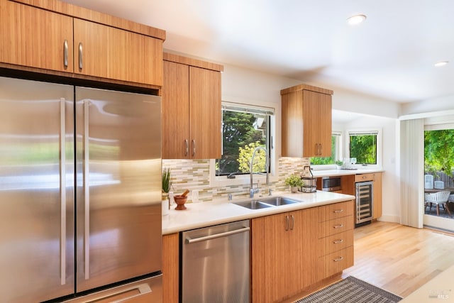 7301 Baker Ln, Sebastopol, CA 95472 - kitchen featuring appliances with stainless steel finishes, a sink, wine cooler, light countertops, and tasteful backsplash