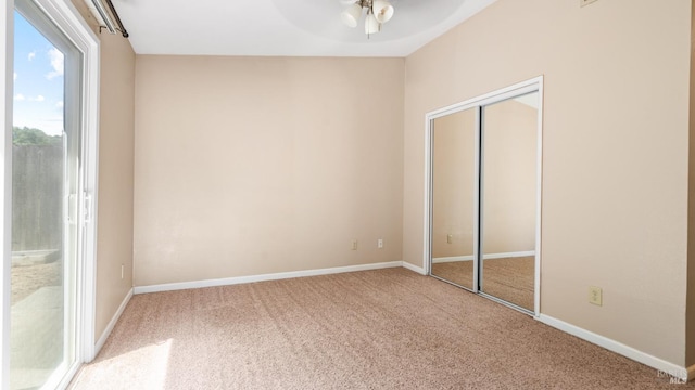 unfurnished bedroom with carpet flooring, a closet, and baseboards