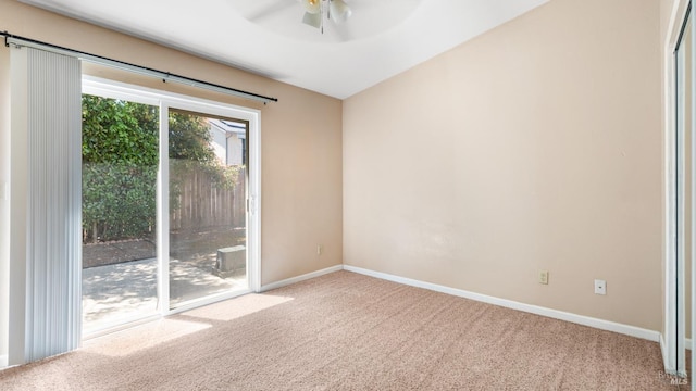 carpeted empty room featuring ceiling fan and baseboards