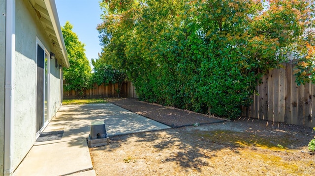 fenced backyard with a patio