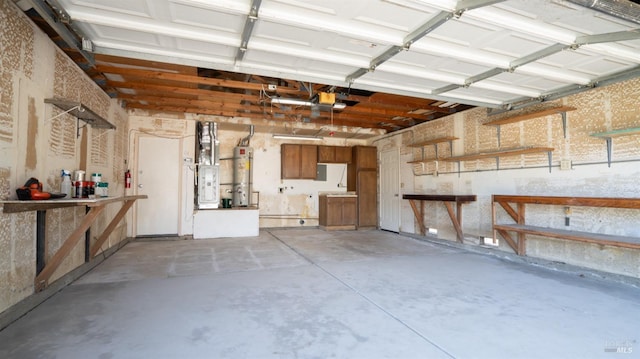 garage with water heater, a workshop area, and a garage door opener