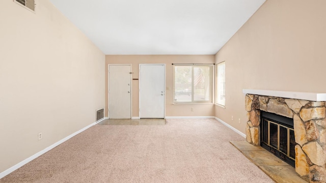 unfurnished living room featuring light colored carpet, a fireplace, and baseboards