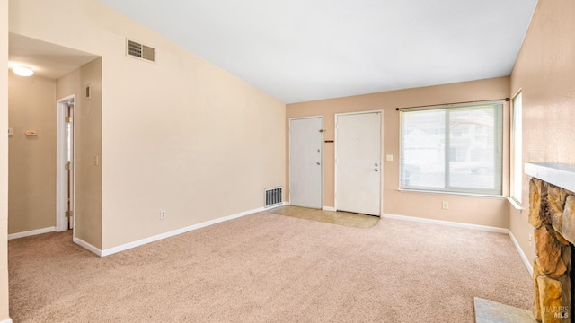 unfurnished living room featuring carpet floors and baseboards