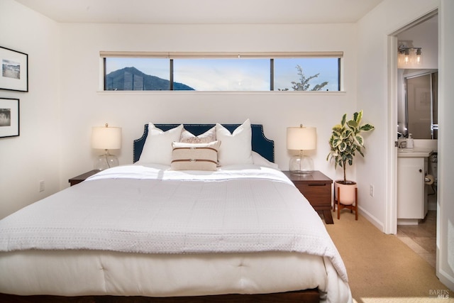 carpeted bedroom featuring multiple windows and baseboards