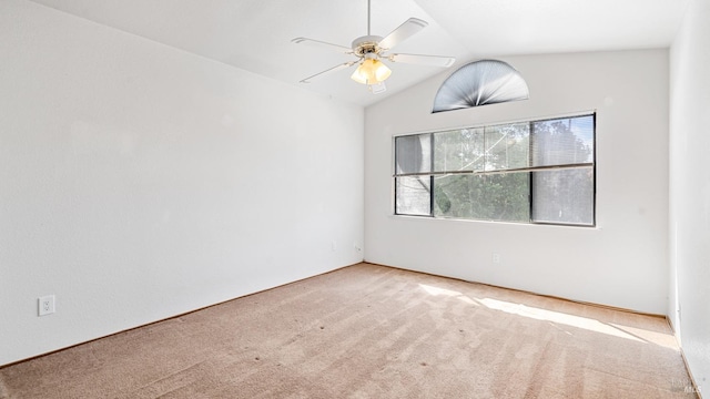 carpeted empty room featuring a ceiling fan and vaulted ceiling