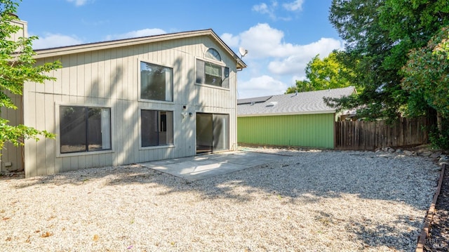 rear view of property with a patio area and fence