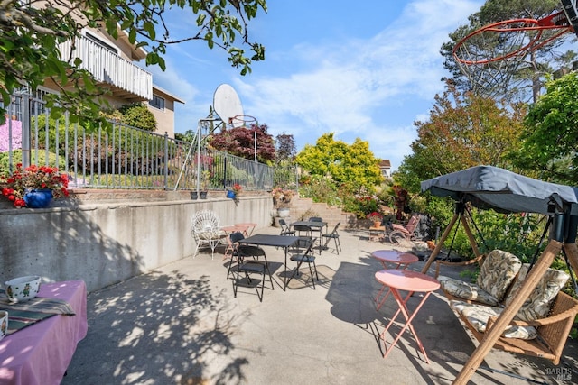 view of patio with fence and outdoor dining area