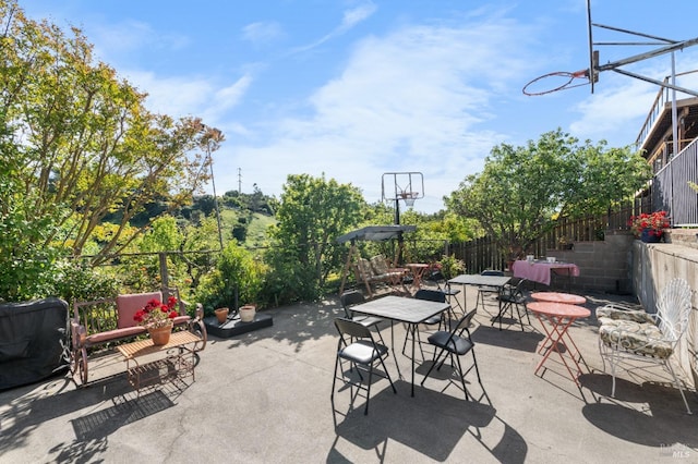 view of patio / terrace with fence and a grill