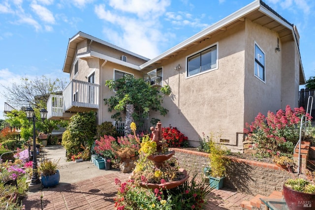 view of home's exterior with stucco siding and a patio area