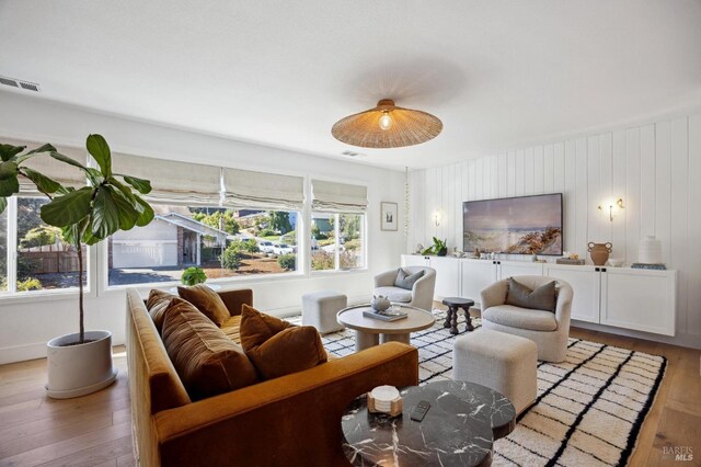 living area with light wood finished floors and baseboards
