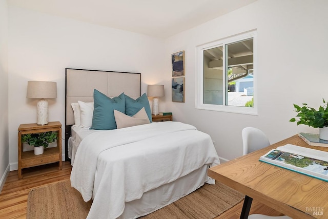 bedroom with wood finished floors and baseboards
