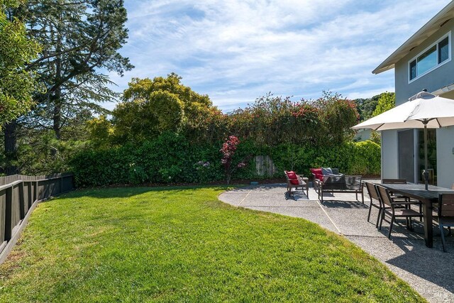 view of yard with a patio area and outdoor dining space