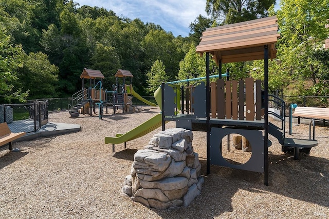 community jungle gym featuring fence
