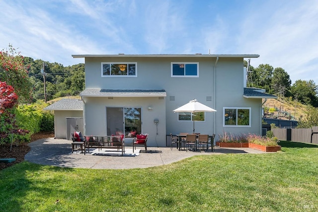 rear view of property featuring a patio and stucco siding