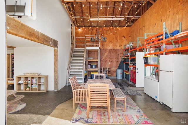 6820 Day Rd, Windsor, CA 95492 - dining area featuring a high ceiling, wood walls, and concrete floors