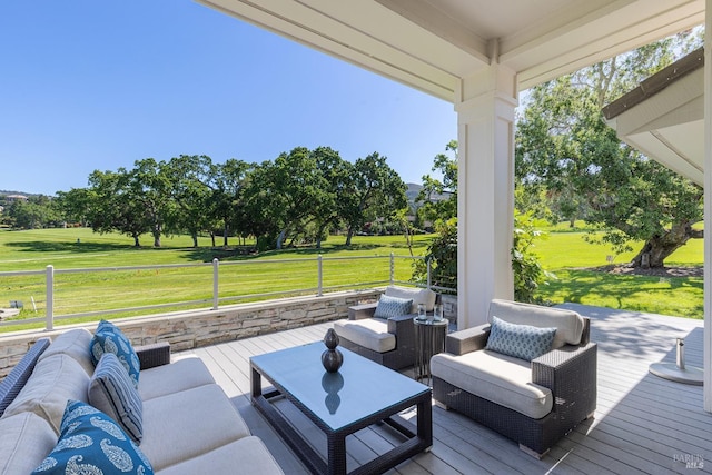 deck featuring outdoor lounge area and a lawn