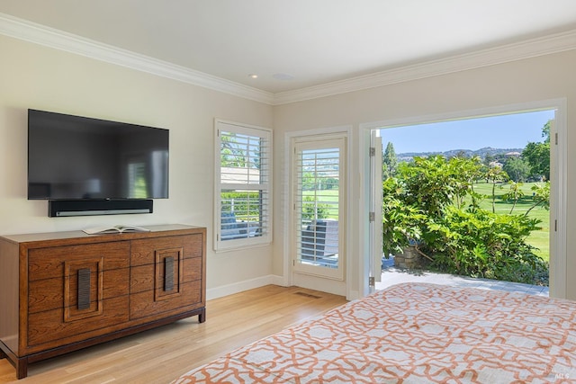 bedroom featuring access to exterior, light wood finished floors, crown molding, and baseboards