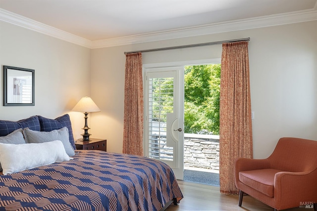 bedroom featuring access to exterior, ornamental molding, and wood finished floors