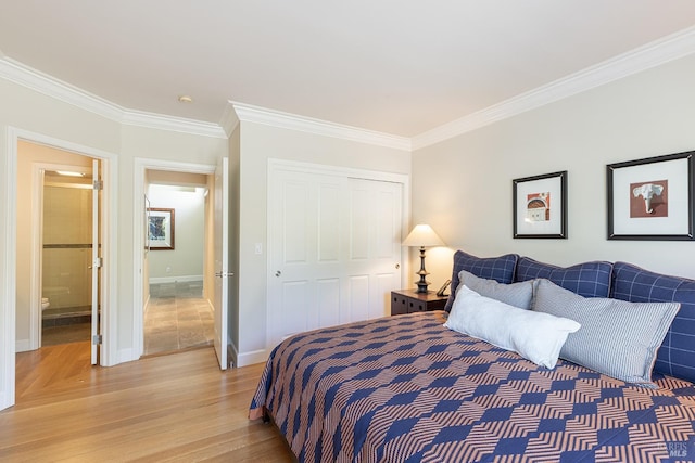 bedroom with ornamental molding, light wood-type flooring, a closet, and baseboards