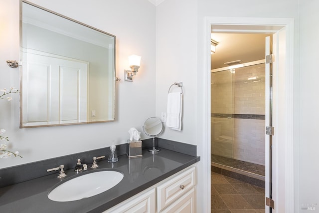 full bathroom featuring a stall shower, vanity, and crown molding