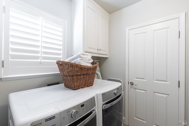 laundry room with cabinet space and separate washer and dryer