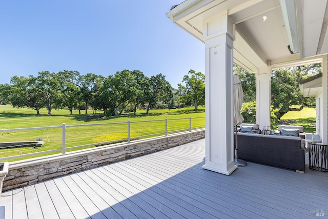 wooden deck with a lawn
