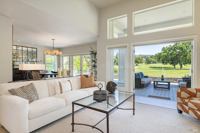 living room featuring a chandelier, recessed lighting, and french doors
