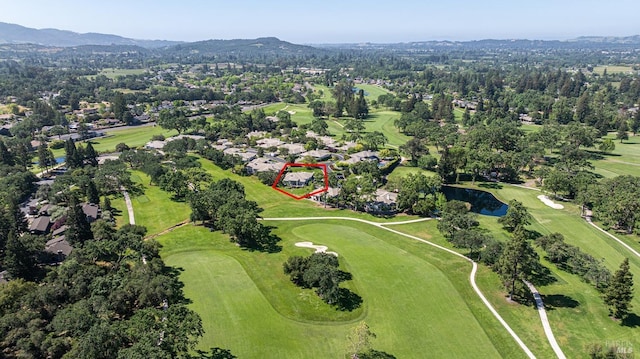 aerial perspective of suburban area with property boundaries highlighted, a golf club, and a water and mountain view