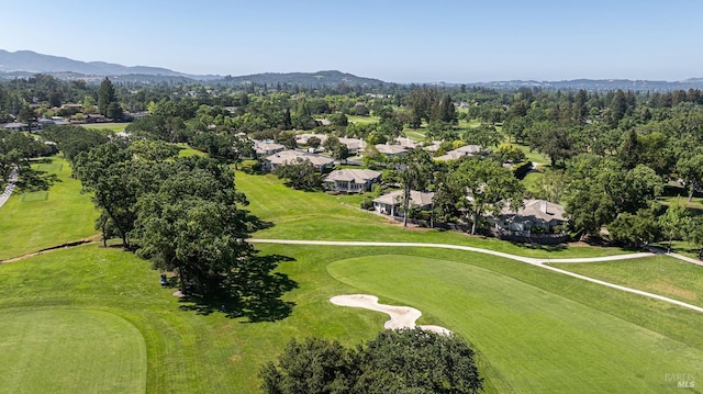 aerial perspective of suburban area featuring a local golf course and mountains