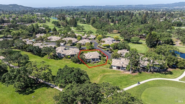 aerial view of residential area with property parcel outlined, a large body of water, and a local golf course