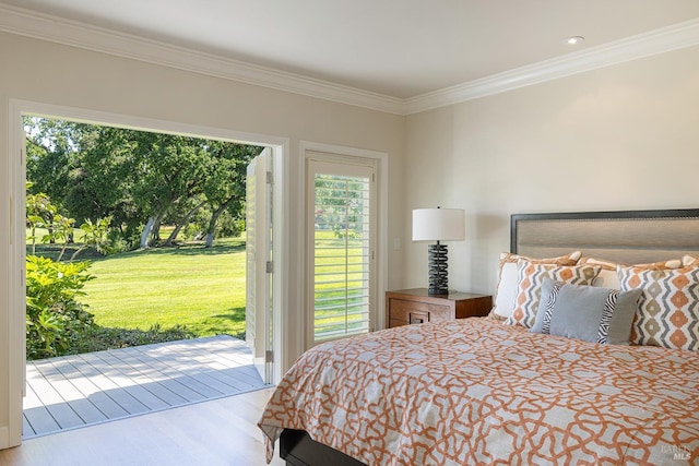 bedroom featuring access to exterior, crown molding, multiple windows, and wood finished floors