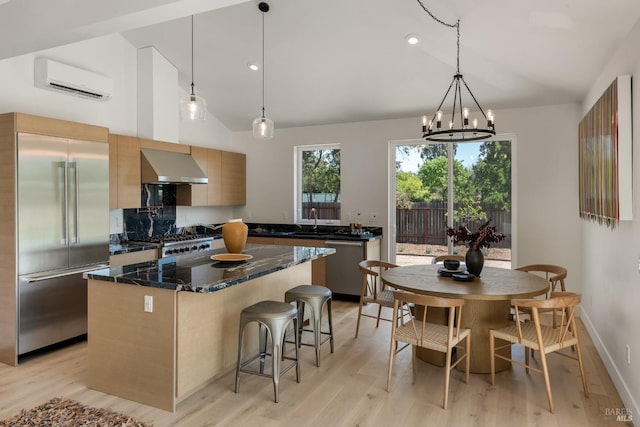 1575 Felder Rd, Sonoma, CA 95476 - kitchen featuring appliances with stainless steel finishes, range hood, a wall unit AC, modern cabinets, and a sink