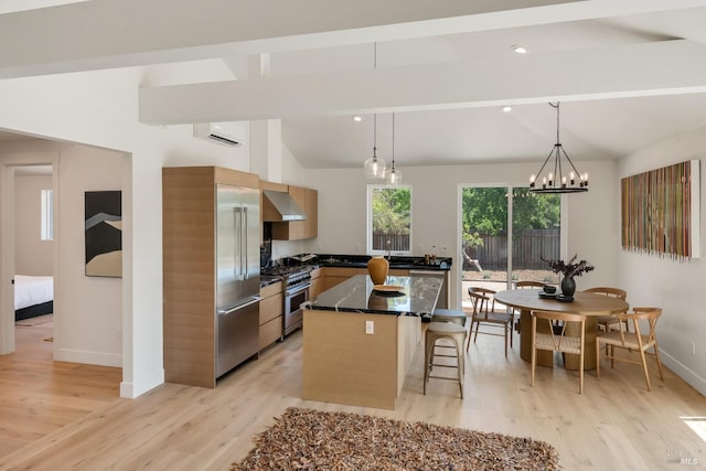 1575 Felder Rd, Sonoma, CA 95476 - kitchen featuring ventilation hood, premium appliances, a kitchen bar, a kitchen island, and light wood-type flooring