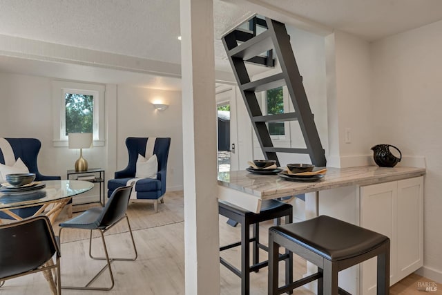 1575 Felder Rd, Sonoma, CA 95476 - dining area with light wood-style flooring, baseboards, and a textured ceiling