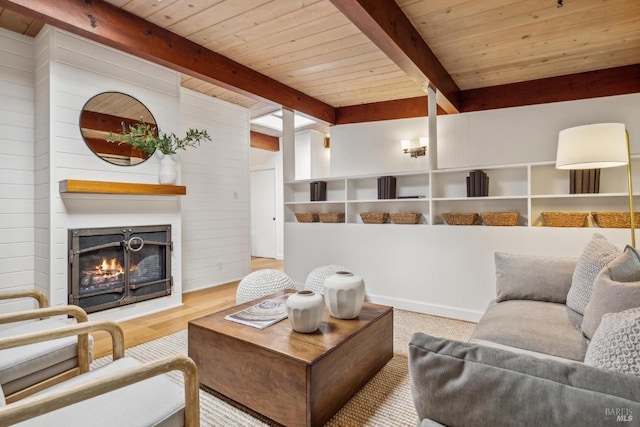 16 Ivy Ln, Woodacre, CA 94973 - living area featuring wood ceiling, beamed ceiling, a glass covered fireplace, wood walls, and wood finished floors