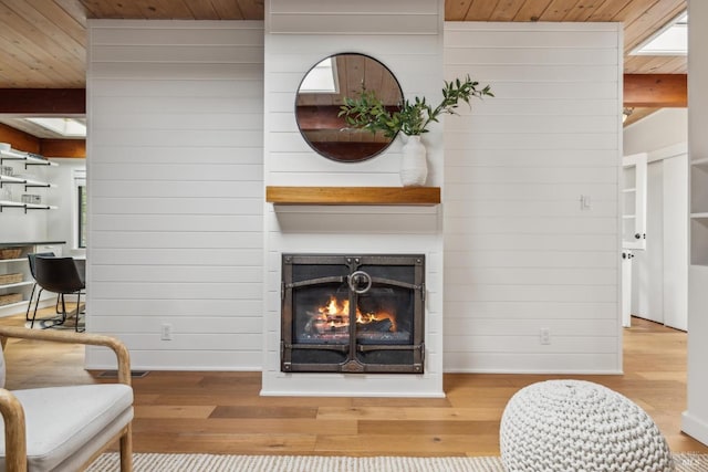 16 Ivy Ln, Woodacre, CA 94973 - living area featuring wood finished floors, a lit fireplace, wooden ceiling, wooden walls, and baseboards