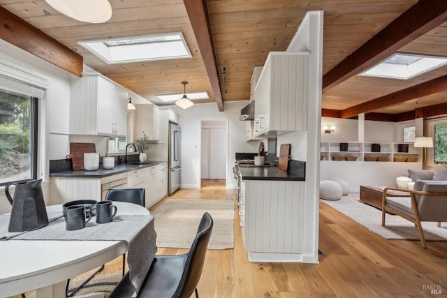 16 Ivy Ln, Woodacre, CA 94973 - kitchen featuring a skylight, a sink, dark countertops, beam ceiling, and high end fridge