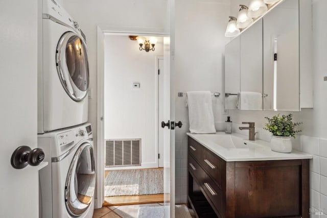 16 Ivy Ln, Woodacre, CA 94973 - bathroom featuring stacked washer / drying machine, vanity, and wood finished floors
