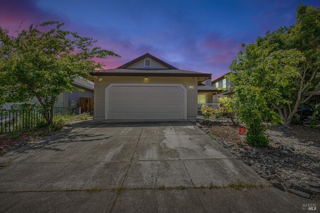 view of front of house with fence and driveway