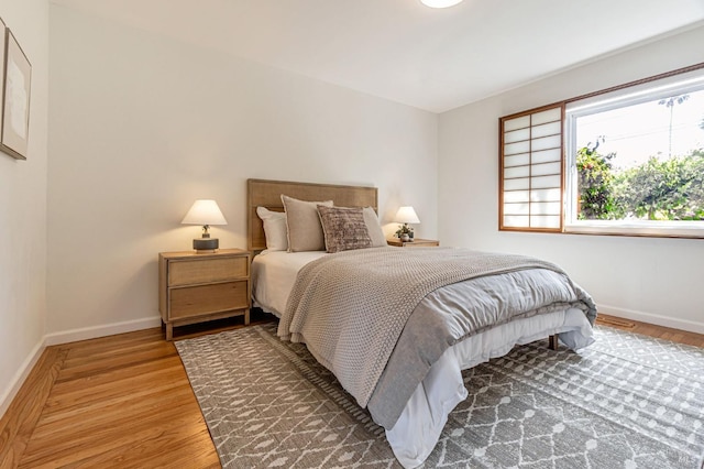 bedroom featuring baseboards and wood finished floors
