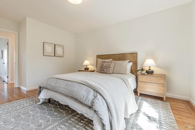 bedroom featuring wood finished floors and baseboards