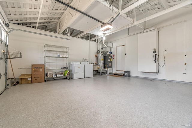 garage featuring washer and dryer and secured water heater
