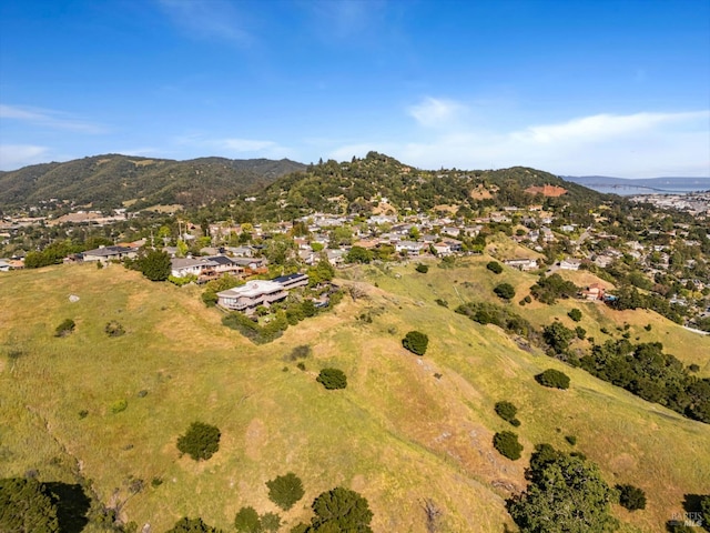 view of property location featuring a mountain backdrop and nearby suburban area