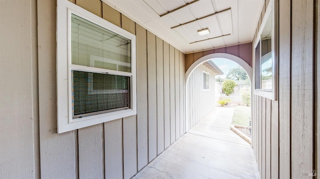 property entrance featuring board and batten siding and a patio