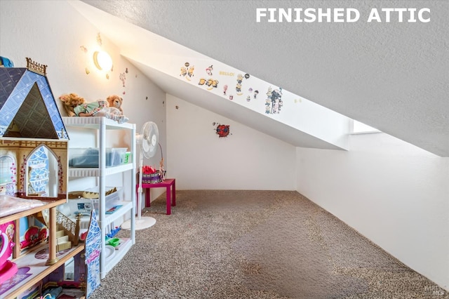 playroom with carpet flooring and a textured ceiling