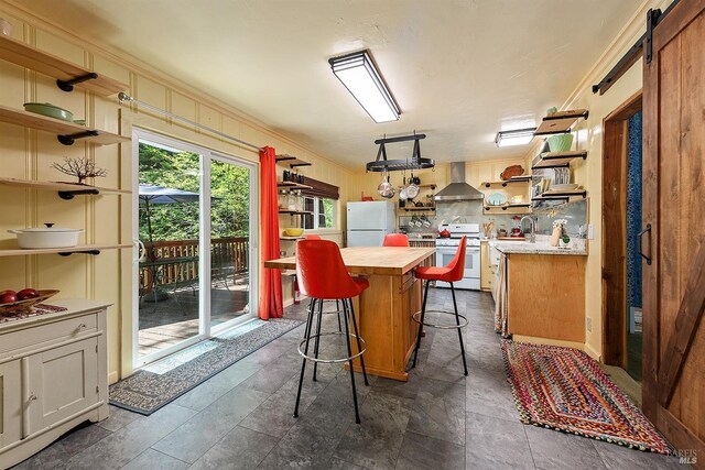 10 Wildwood Ln, Cazadero, CA 95421 - kitchen featuring white appliances, wall chimney exhaust hood, open shelves, wood counters, and a center island