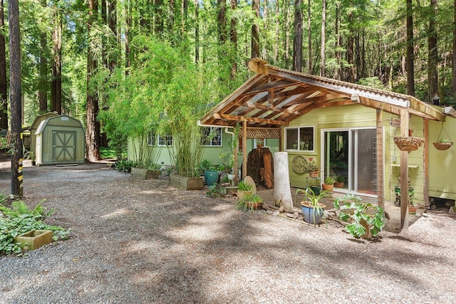 10 Wildwood Ln, Cazadero, CA 95421 - chalet / cabin featuring a storage unit, an outbuilding, and a view of trees