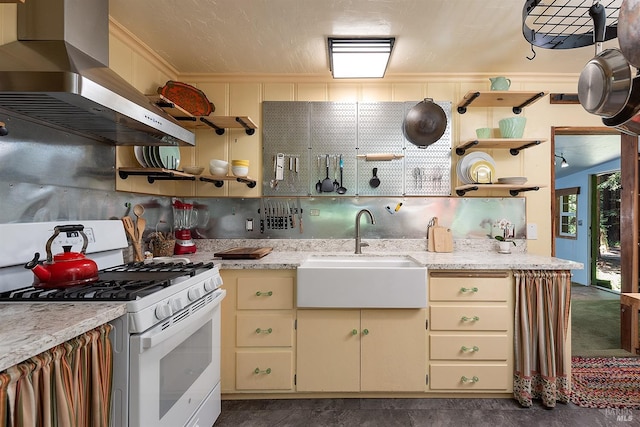 10 Wildwood Ln, Cazadero, CA 95421 - kitchen featuring gas range gas stove, open shelves, wall chimney exhaust hood, cream cabinets, and a sink