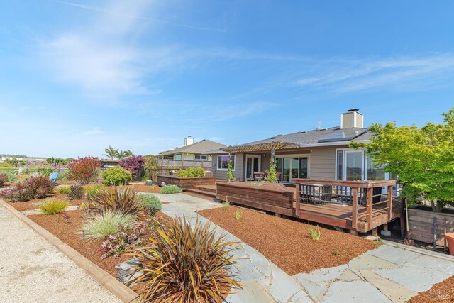 199 Golden Hind Psge, Corte Madera, CA 94925 - back of house featuring solar panels, a chimney, and a wooden deck