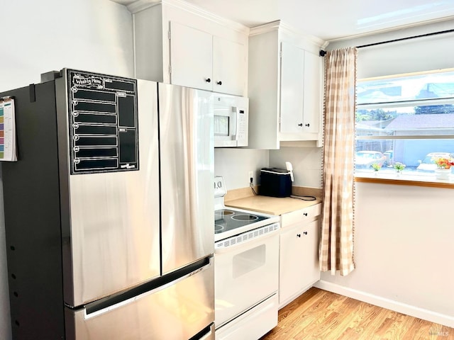 kitchen with white appliances, white cabinetry, light wood-type flooring, light countertops, and crown molding
